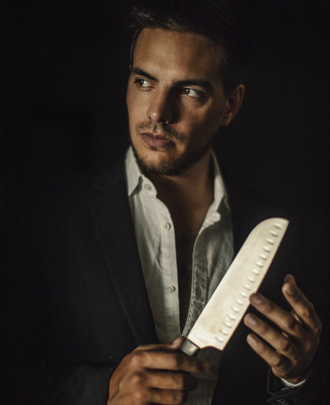 Editorial portrait of a male model in a dark suit