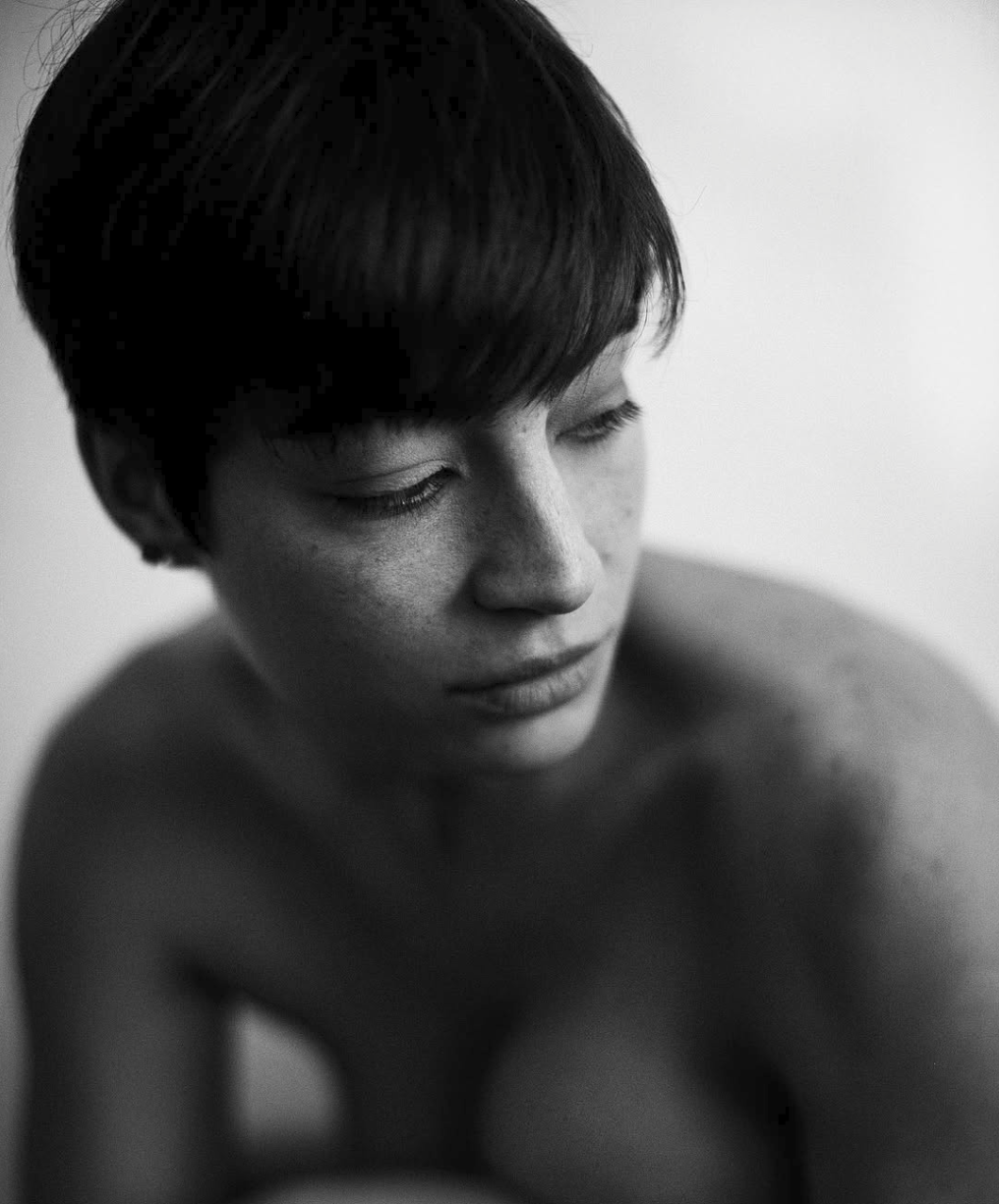 Black and white editorial portrait of a male model